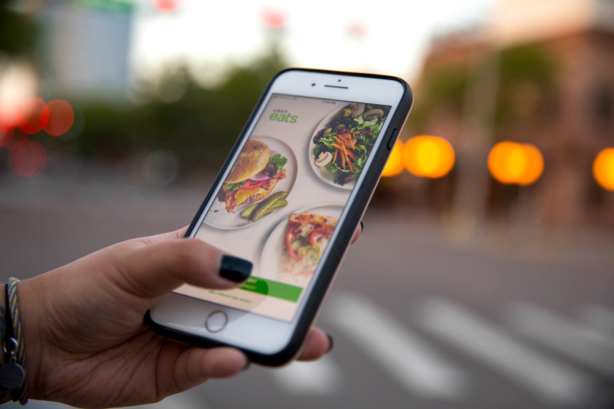 A woman looks at what's offered on Uber Eats.