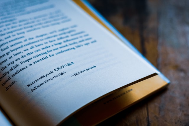 Page of a book with a Japanese proverb written on it