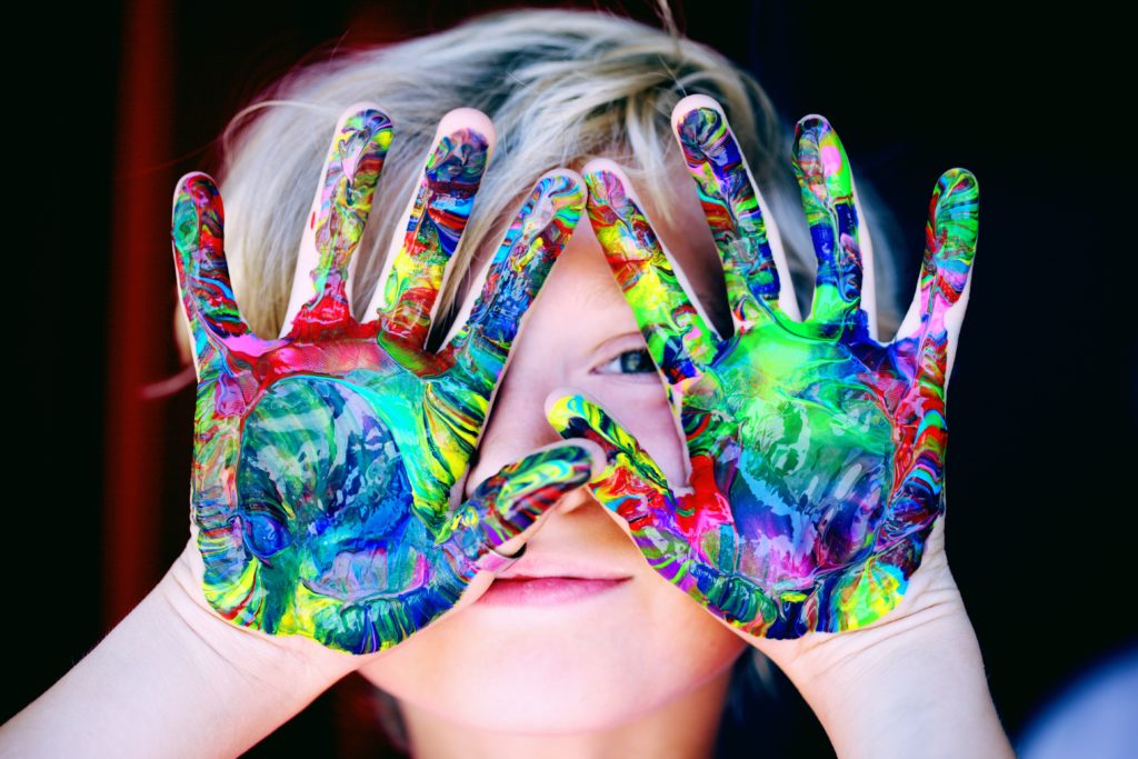 a girl with paint on her hands